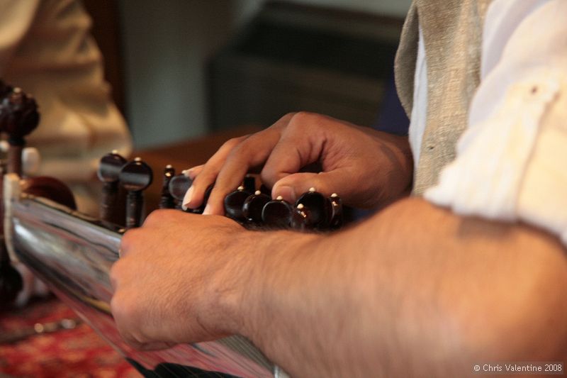 Tarun Jasani tunes his Sarod. There are two sets of tuning pegs, the further ones for the longer strings, which are spaced further apart, and the closer ones for a second set of strings that are close together.