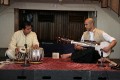 Udit Pankhania (left, playing Table) and Tarun Jasani (right, playing Sarod) at Walton Church, The Open University, 25-Jun-2008.\n\nThe body of the Sarod is of course hollow and has a top layer of goat skin; the bridge is made from bone and because of the use of metal strings, wears down with time.\n\nThe box in the middle at the back is an electronic drone; being electronic, its pitch doesn't drift in different conditions, meaning the two players have something they can tune to. Its sound would traditionally be played by another musician on a Tambura.